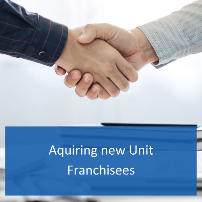 2 men shaking hands, new unit franchisee Handshake of two men closing the deal on a new unit franchise